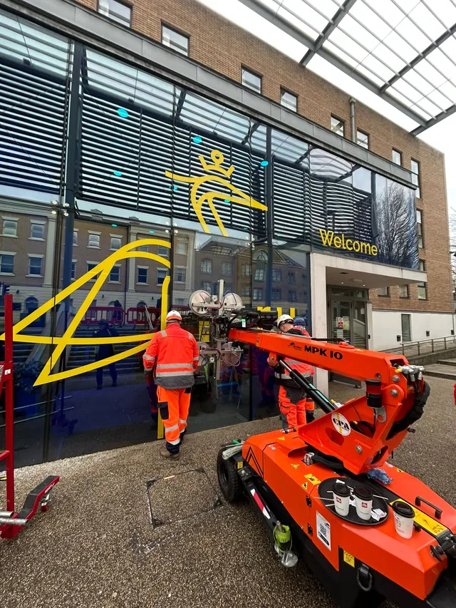 Workmen replacing commercial glass