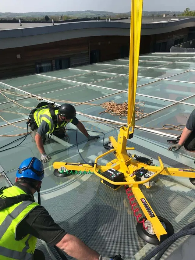 Workmen working on commercial glass roof