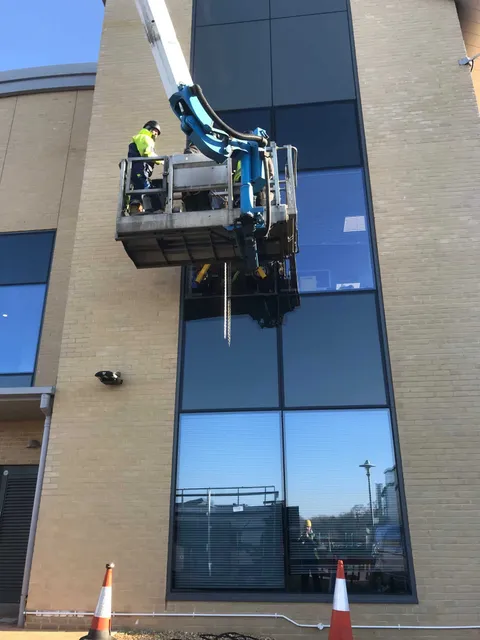 Using a cherry picker to replace curtain wall