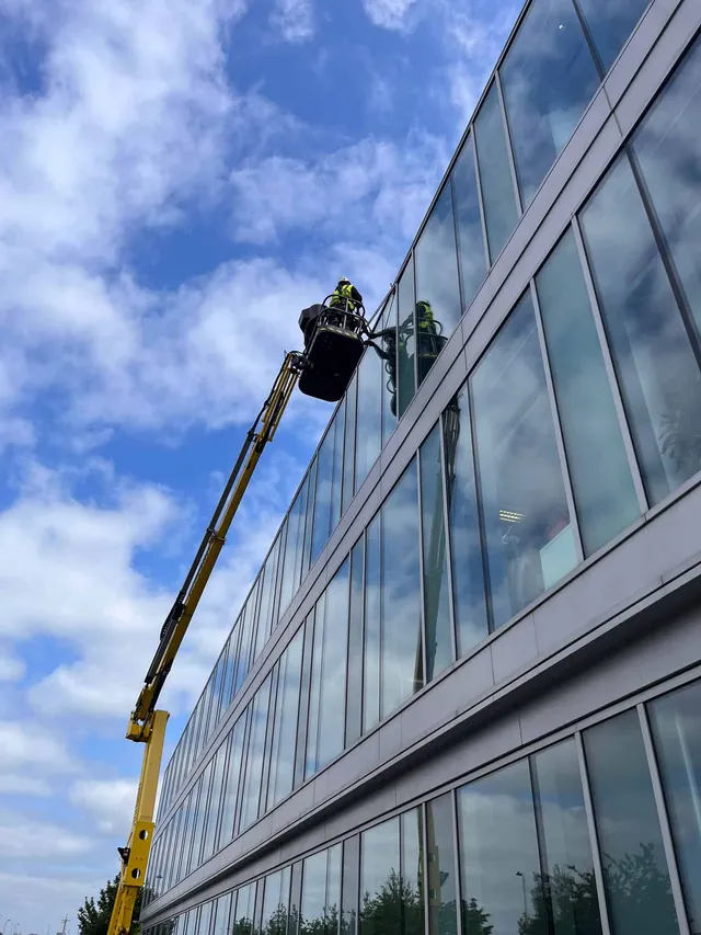 Using a cherry picker to fix leak in glass