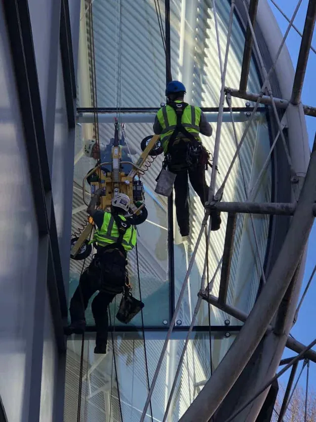Workmen working on glass replacement