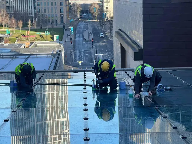 Workmen working on a glass roof repair