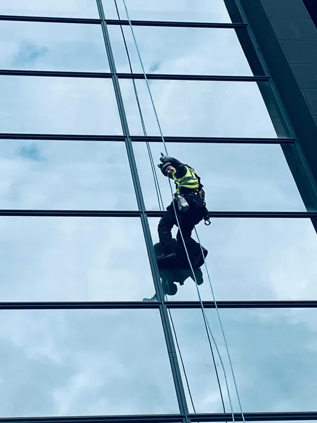 Using ropes to inspect a glass facade