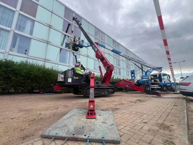 Using a crane to reach high hotel glass