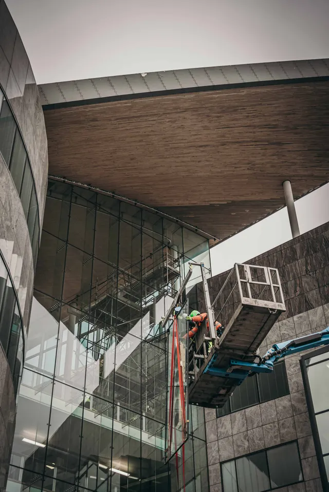 Workmen replacing specialist glazing